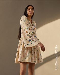 V-neck Dress With Intricate Multicolor Embroidery, Beige Bell Sleeve Dress, Folk Style V-neck Dress With Embroidered Hem, Elegant Embroidered Bell Sleeve Dress, Traditional V-neck Embroidered Dress, Elegant Bell Sleeve Embroidered Dresses, Bohemian Beige Embroidered Dress With Intricate Details, Multicolor Embroidered Long Sleeve Embellished Dress, Multicolor Embroidered Dress With Embroidered Sleeves