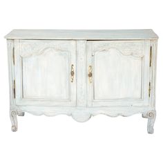 an old white wooden cabinet with two doors