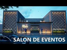 the salon de eventos is lit up at night with people walking outside and cars parked in front