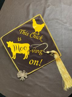 this is a graduation cap that says, this chick is living on it with a cow and hen