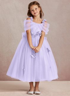 Shaylee is an enchanting A-line flower girl dress that is crafted from delicate tulle. She features intricately handmade 3D flower embellishments. Off-shoulder sleeves offer a touch of whimsy that is complimented with a tulle bow back. The flowers cascade gracefully down the tulle skirt that flows with every step. Lilac Flower Girl Dresses, Purple Flower Girls, Purple Flower Girl Dress, Taylor Outfits, Tulle Bow, Wedding Green, Flower Embellishments, Tulle Flower Girl, Tulle Bows