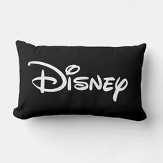 a black and white pillow with the word disney printed on it's front side