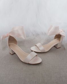 Classy satin block heel with satin ribbon ankle tie. Simple yet elegant are great combination and will definitely be a favorite.DETAILS:FIT: RUNS LARGE, ORDER ONE SIZE DOWNHEEL HEIGHT: 1.25 inches (kids) & 2 inches (women)RIBBON WIDTH: 1.5 inchesCOLORS AVAILABLE: Black, Burgundy, Champagne, Ivory, Navy, White, Light Blue, & Soft BlushUPPER: Synthetic upper and liningMATERIALS: Mandmade outsole STYLE NAME: NAOMI Pink Wedding Shoes, Wedding Aesthetics, Heels Aesthetic, Platform Shoes Heels, Bridal Heels, Bridesmaid Shoes, Blue Soft, Ankle Strap Pumps, Bride Shoes