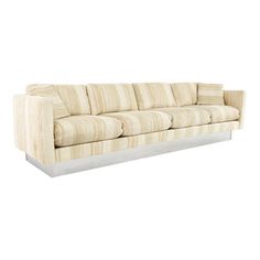 a white couch sitting on top of a wooden floor