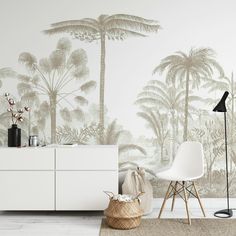 a living room with palm trees on the wall and a rug in front of it