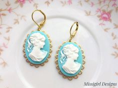 These beautiful Cameo earrings were created with 18x25mm brass scalloped settings adorned with 18x25mm Aqua blue cameo cabochons and brass lever back ear wires. These gorgeous earrings hang beautifully from lever back ear wires and measure 1 3/4 inches in length and 3/4 inches in width. These earrings are very romantic and chic...You will truly enjoy these for many years to come. *All of my listings are handmade with love and ready to ship and will arrive to you in a gift box with bow for easy g Blue Cameo Jewelry For Wedding, Turquoise Dangle Clip-on Earrings For Gift, Turquoise Dangle Clip-on Earrings As Gift, Turquoise Clip-on Earrings As Gift, Blue Cameo Jewelry Gift, Turquoise Clip-on Jewelry For Gift, Turquoise Clip-on Jewelry Gift, Cameo Drop Earrings For Gifts, Victorian Earrings