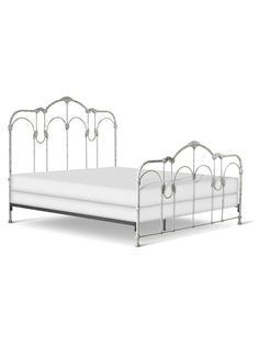 a metal bed frame with white sheets and headboard, on an isolated white background