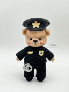 a crocheted teddy bear dressed as a police officer