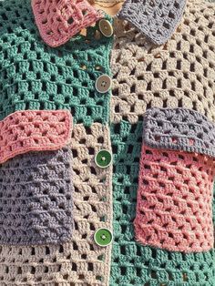 there is a crocheted shirt with buttons on the collar and two different colors