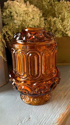 a glass vase sitting on top of a table