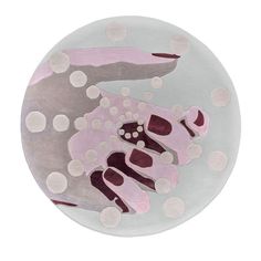 a plate with an animal painted on it's side and polka dots around the edges