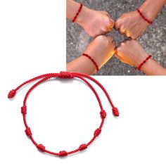 two hands holding each other with red string bracelets on top of the image and below