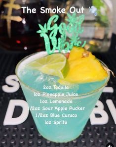 a blue drink with lemon and lime garnish on the rim