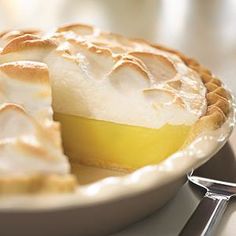 a lemon pie on a plate with a fork