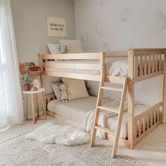 there is a bunk bed in the corner of this room with white walls and carpet on the floor