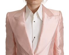 Step into luxury with this stunning Dolce & Gabbana blazer jacket. Crafted from pure silk, this single breasted jacket exudes sophistication with its lustrous pink satin finish, peak lapel, and chic one-button closure. Tailored in Italy, it’s a testament to exquisite craftsmanship and timeless style, complete with elegant logo details. Perfect for exclusive events or enhancing your upscale day-to-day wardrobe. Material: 100% Silk Lining: 92% Silk, 8% Elastane Color: Pink Country of origin: Italy Model Blazer, Silk Blazer, Woman Suit, Satin Blazer, Satin Long Sleeve, Woman Suit Fashion, Peak Lapel, Elegant Logo, Dolce E Gabbana