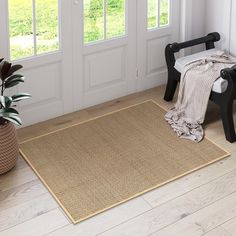 a chair sitting in front of a door with a rug on the floor next to it