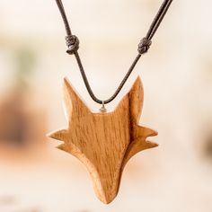 a wooden necklace with an animal's head on it