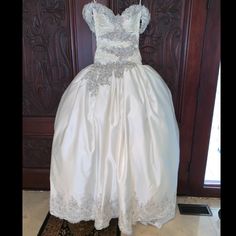 Galit Couture Size 10 Wedding Dress, Never Worn Unaltered Dress With Detachable Sleeves, Retail Price $9,500 Size 10 Bust 39.5 Waist 30.5 Hips 42 Height 5”9 Silhouette: Ball Gown Neckline: Sweetheart (Strapless) Waistline: Dropped Waist Sleeve Style: Capped Sleeve Back Style: Corset/Lace-Up Back Dress Length: Floor Length Colors: Shades Of Ivory Luxury Wedding Ball Gown With Sweetheart Neckline, White Satin Wedding Dress With Detachable Train, Elegant Ball Gown With Detachable Train For Ceremony, Satin Ball Gown With Detachable Train For Wedding, Satin Wedding Dress With Detachable Train And Fitted Bodice, Fitted Bodice Ball Gown With Detachable Train For Ceremony, Ceremony Ball Gown With Detachable Train And Fitted Bodice, Ceremonial Ball Gown With Detachable Train And Fitted Bodice, White Wedding Dress With Detachable Train And Fitted Bodice