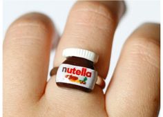 a person's hand with a nutella ring on it