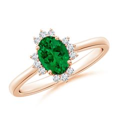 a ring with an oval green stone surrounded by diamonds