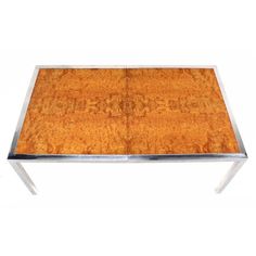 a wooden table with metal legs and a wood surface on the top, against a white background