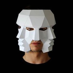 a man wearing a paper mask with his face cut out to look like he is looking at the camera