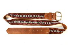 Laredo Unisex Leather Belt in Red by SouldierSouldier belts are made of high-end waxed leather coupled with our 'Laredo' fabric and manufactured in the USA.  The same fabric seen on our famous guitar straps is now available in a high-end unisex belt.  The Souldier name is branded into the belt loop and secured with nickel rivets.  All nickel hardware on the belt and available in even numbered sized from 28 to 42. The measurements reflect the minimum and maximum length of each belt size. Please c Adjustable Embroidered Leather Belt, Traditional Leather Belts For Festivals, Jimi Hendrix Woodstock, Famous Guitars, Boutique Guitar, Guitar Straps, Candy Apple Red, Nickel Hardware, Guitar Strap