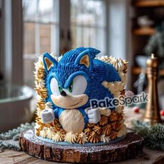 a blue and white cake sitting on top of a wooden table