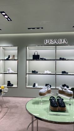 the inside of a prada store with shoes on display