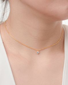 "LISTING Dainty Chain Necklace DETAILS * Charm: faceted round 0,16\" (4mm) white zirconia We offer 4 chain lengths: * Chain 1: 15.7\" (40cm) length Levels of adjustment 13.8\"- 15.7\" (35 - 40cm). * Chain 2: 17.7\" (45cm) length Levels of adjustment: 16.9\" (43cm) and 15.7\" (40cm). * Chain 3: 19.7\" (50cm) length Levels of adjustment: 18.5\" (47cm) and 17.3\" (44cm). * Chain 4: 21.7\" (55cm) length Levels of adjustment: 20.5\" (52cm) and19.3\" (49cm). * The model is wearing multiple necklaces. Minimalist White Diamond Necklace, Minimalist Gold Solitaire Necklace With Cubic Zirconia, Minimalist Diamond Necklace With Birthstone, Minimalist Solitaire Pendant Necklace With Clavicle Chain, Minimalist White Solitaire Necklace With Clavicle Chain, Minimalist Rose Gold Solitaire Necklace With Clavicle Chain, Minimalist Round Pendant Birthstone Necklace, Minimalist Diamond Necklace With Round Pendant And Clavicle Chain, Minimalist Solitaire Necklace With Adjustable Chain