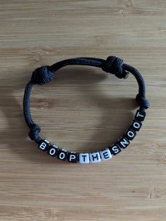 BOOP THE SNOOT bracelet  Black Paracord  Black and white letters Adjustable  One size fits most. If you would like exact measurements please ask or if you would like a custom size just let me know!  Ready to ship! ✈️ Black Casual Customized Bracelets, Casual Black Wristband With Letter Beads, Casual Black Customized Bracelets, Adjustable Black Wristband With Letter Beads, Customized Adjustable Black Wristband, Personalized Black Casual Wristband, Adjustable Customized Black Wristband, Custom Name Adjustable Wristband, Customized Black Casual Wristband