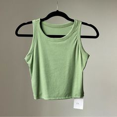 Size M New With The Tag 70.5% Rayon 23.5% Polyester 6% Spandex Basic Green Stretch Crop Top, Basic Green Tank Top, Green Stretch Basic Tank Top, Casual Green Stretch Tank Top, Casual Green Seamless Tank Top, Basic Green Tank Top For Summer, Green Basic Tank Top For Summer, Green Summer Workout Tops, Summer Workout Tops Seamless