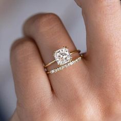 a woman's hand with a diamond ring on top of her finger and the words perfebling new york written below it