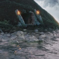 two large rocks sitting on top of a body of water