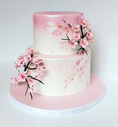 a three tiered cake with pink flowers on it