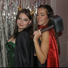 two young women dressed up in costumes posing for the camera