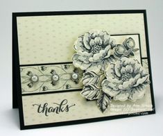 a close up of a card with flowers and pearls on the bottom, in black and white