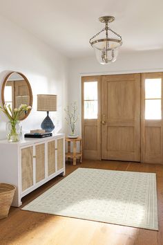 a living room with wooden floors and white walls