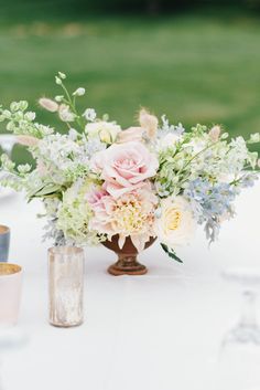 a vase with flowers on top of a table