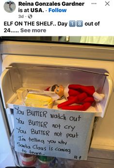 an elf is sitting in the refrigerator with his handwritten message