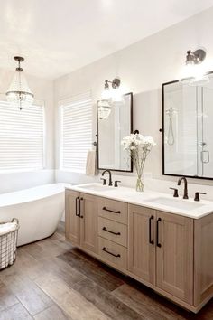 a large bathroom with two sinks and a tub