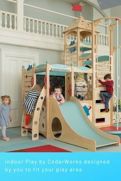 a child's play area with two children playing on the slide and another child standing in front of it