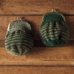 two green and white knitted purses sitting on top of a wooden floor next to each other