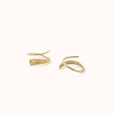 Just like magic - these 14k solid gold twist earrings give the illusion of an extra piercing. Elegant 14k Gold Ear Cuff With Ear Wire, Modern Twist 14k Gold Earrings For Formal Occasions, Modern Twist 14k Gold Formal Earrings, Modern Twist Yellow Gold Earrings With Polished Finish, Modern Twist Polished Yellow Gold Earrings, 14k Yellow Gold Twisted Earrings, Twisted 14k Yellow Gold Earrings, Modern Twist 14k Yellow Gold Earrings, Modern 14k Yellow Gold Ear Climbers