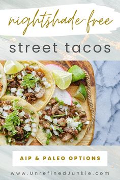 three tacos on a plate with limes and cilantro in the background