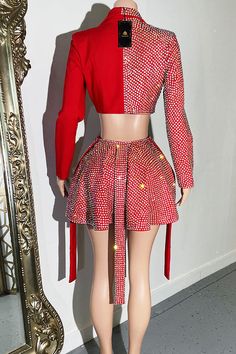 the mannequin is wearing a red jacket and skirt