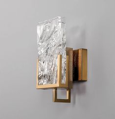 a wall mounted light with a glass block on it