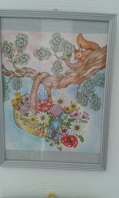 a painting hanging on the wall with flowers and a squirrel in it's basket