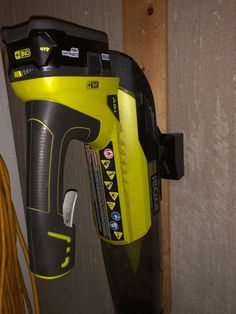 a cordless drill is attached to a wooden wall